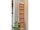 A narrow, built-in pantry with shelves provides storage for dry goods and spices at 4034 E Aster Dr, Phoenix, AZ 85032