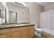 Bathroom featuring granite countertops, wooden cabinets, and shower with curtain at 420 W First St # 217, Tempe, AZ 85281