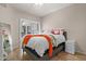Bright bedroom with shutters, light walls, orange blanket and neutral decor at 420 W First St # 217, Tempe, AZ 85281