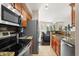Well-equipped kitchen with stainless steel appliances and granite countertops open to living area at 420 W First St # 217, Tempe, AZ 85281