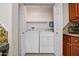Enclosed laundry area with a side-by-side washer and dryer plus overhead shelving at 420 W First St # 217, Tempe, AZ 85281