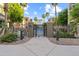 Gated entrance to the community pool area, surrounded by lush landscaping and palm trees at 420 W First St # 217, Tempe, AZ 85281