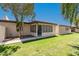 Grassy backyard with a large patio, green grass, and a walkway to the property at 4501 E Carol Ave # 68, Mesa, AZ 85206