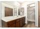 Bathroom with a double vanity, large mirror, shower, and closet space at 4501 E Carol Ave # 68, Mesa, AZ 85206