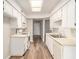 Well-maintained kitchen featuring white cabinets, white appliances, and a skylight providing natural light at 4501 E Carol Ave # 68, Mesa, AZ 85206