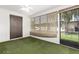 Bright sun room with a ceiling fan and a sliding glass door that leads to the back yard at 4501 E Carol Ave # 68, Mesa, AZ 85206