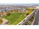 Wide aerial view of community featuring lush green space, homes, and a glimpse of city amenities at 4619 N 179Th Dr, Goodyear, AZ 85395