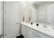 Bathroom featuring dual sinks, a large mirror, and white cabinetry, offering style and functionality at 4619 N 179Th Dr, Goodyear, AZ 85395