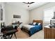 Cozy bedroom featuring neutral walls, ceiling fan, and stylish decor, including a desk with music equipment at 4619 N 179Th Dr, Goodyear, AZ 85395