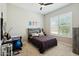 Comfortable bedroom with a ceiling fan, natural light from plantation shutters, and a desk area at 4619 N 179Th Dr, Goodyear, AZ 85395