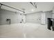 Spacious garage with epoxy floor, ample lighting, and convenient electric car charging station at 4619 N 179Th Dr, Goodyear, AZ 85395