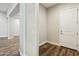 Hallway with wood floors, fresh white paint, baseboards, and a bright, welcoming atmosphere at 4619 N 179Th Dr, Goodyear, AZ 85395