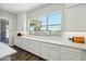 Bright eat-in kitchen with a large window and a sign that says 