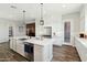 Bright kitchen with a large island, stainless steel appliances, and wood-look floors at 4619 N 179Th Dr, Goodyear, AZ 85395