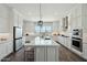Bright kitchen with a large island, stainless steel appliances, and plenty of cabinet space at 4619 N 179Th Dr, Goodyear, AZ 85395