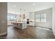 Bright, open kitchen featuring a large island with seating, stainless steel appliances, and modern pendant lighting at 4619 N 179Th Dr, Goodyear, AZ 85395