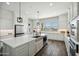 Spacious kitchen features a large island with stainless steel sink and modern stainless steel appliances at 4619 N 179Th Dr, Goodyear, AZ 85395