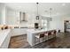 Modern kitchen with a large island, stainless steel appliances, white cabinets, and pendant lighting at 4619 N 179Th Dr, Goodyear, AZ 85395
