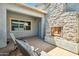 Covered patio featuring a stone fireplace and chairs at 4619 N 179Th Dr, Goodyear, AZ 85395