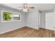 Bedroom featuring hard surface floors, natural light from the window, and a ceiling fan at 4735 S Mill Ave, Tempe, AZ 85282