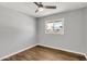 Comfortable bedroom space with wood-look flooring, a ceiling fan, and a window at 4735 S Mill Ave, Tempe, AZ 85282