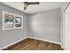 This is a comfortable bedroom space with wood-look flooring and a window at 4735 S Mill Ave, Tempe, AZ 85282