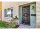 Close up of brick townhouse entrance with security door and small manicured landscape at 4735 S Mill Ave, Tempe, AZ 85282