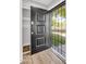Entryway with black security door, wood flooring and closet to the left at 4735 S Mill Ave, Tempe, AZ 85282
