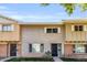 View of tan and brown two-story townhouse with brick facade, sidewalk and green lawn at 4735 S Mill Ave, Tempe, AZ 85282