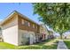 View of tan and brown two-story townhouse with brick facade, sidewalk and green lawn at 4735 S Mill Ave, Tempe, AZ 85282