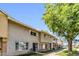 View of tan and brown two-story townhouse with brick facade, sidewalk and green lawn at 4735 S Mill Ave, Tempe, AZ 85282