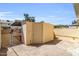 A utility shed sitting on a concrete pad with a chain link fence at 4735 S Mill Ave, Tempe, AZ 85282