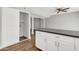 This kitchen area features an island, lots of cabinet space, and wood-look flooring at 4735 S Mill Ave, Tempe, AZ 85282