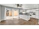 Modern kitchen with white cabinets, island sink, and glass sliding doors at 4735 S Mill Ave, Tempe, AZ 85282