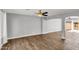 Spacious living room with hardwood floors and a ceiling fan, leads to an outdoor area at 4735 S Mill Ave, Tempe, AZ 85282