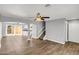 Bright living room with hardwood floors, ceiling fan, and open access to kitchen and backyard at 4735 S Mill Ave, Tempe, AZ 85282