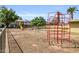 Community playground including monkey bars, swings, and a slide surrounded by pea gravel at 4735 S Mill Ave, Tempe, AZ 85282
