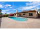 Backyard featuring a pool, plants, grass, and a covered patio at 5337 W Diana Ave, Glendale, AZ 85302