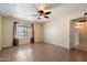 Large bedroom featuring tiled flooring, ceiling fan, window and access to a bathroom at 5337 W Diana Ave, Glendale, AZ 85302