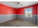 Bedroom with window, carpeted floor, red and gray paint at 5337 W Diana Ave, Glendale, AZ 85302