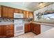 Traditional kitchen with tile floors, warm wood cabinets, stainless steel appliances, and lots of natural light at 5337 W Diana Ave, Glendale, AZ 85302