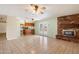 Inviting living room features tiled floors, a fireplace, and access to backyard with French doors at 5337 W Diana Ave, Glendale, AZ 85302