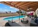 Backyard oasis with a refreshing pool, covered patio, and comfortable outdoor seating at 5337 W Diana Ave, Glendale, AZ 85302