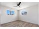 Well-lit bedroom featuring two windows and modern ceiling fan at 5452 E University Dr, Mesa, AZ 85205