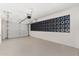 Spacious garage with white walls, concrete floor, a window feature, and an automatic door at 5452 E University Dr, Mesa, AZ 85205