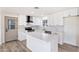 Open kitchen with stainless steel appliances, marble countertops, and a door with decorative glass at 5452 E University Dr, Mesa, AZ 85205