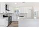 Bright and airy white kitchen featuring a new stainless steel appliance, island, and stylish countertops at 5452 E University Dr, Mesa, AZ 85205