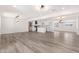 Spacious open floor plan with new luxury vinyl floors connecting the living room and kitchen at 5452 E University Dr, Mesa, AZ 85205