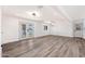 Open living area featuring modern lighting, French doors, and new luxury vinyl flooring throughout at 5452 E University Dr, Mesa, AZ 85205