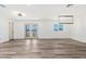 Spacious living room with hardwood floors, modern lighting, and french doors to the backyard at 5452 E University Dr, Mesa, AZ 85205